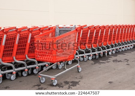 red plastic baskets-carts for warehousing of food and household goods upon purchase in shops and in markets