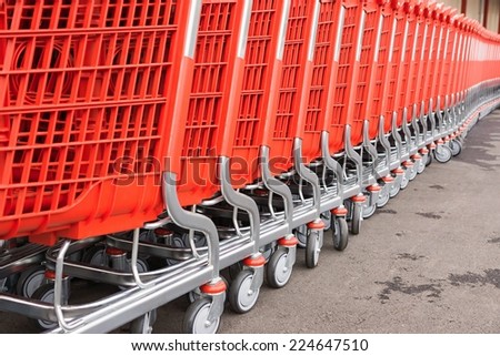 red plastic fragments of a baskets-carts for warehousing of food and household goods upon purchase in shops and in markets