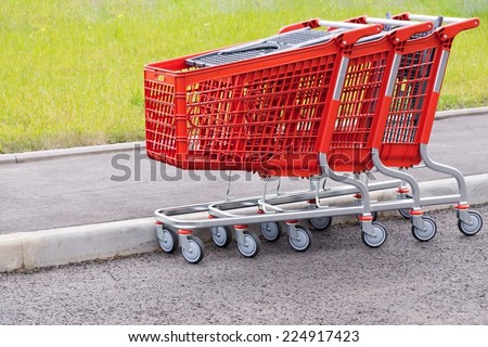 red baskets-carts for warehousing of food and household goods upon purchase in shops and in markets