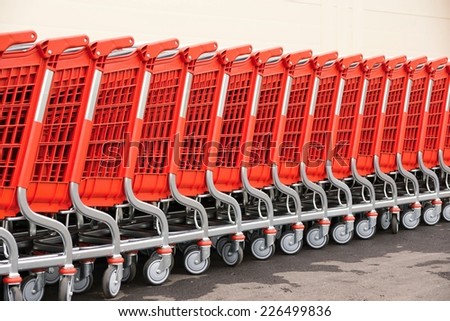 abstract fragments of red baskets-carts for warehousing of food and household goods upon purchase in shops and in markets