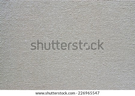 abstract texture of rough cotton fabric or canvas with drawing from fibers a cross crosswise for backgrounds of gray color