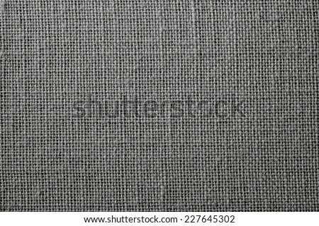 the textured background of synthetic fabric with crisscross fibers of black color