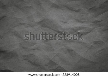the abstract textured background from crumpled mesh with small cells synthetic fabric of black color