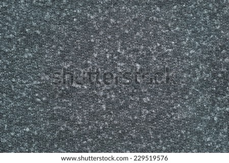 abstract textural background from knitted fleecy synthetic fabric of dark gray-green color for tailoring of warm outerwear