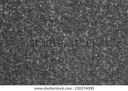 abstract textural background from knitted fleecy synthetic fabric of black color for tailoring of warm outerwear