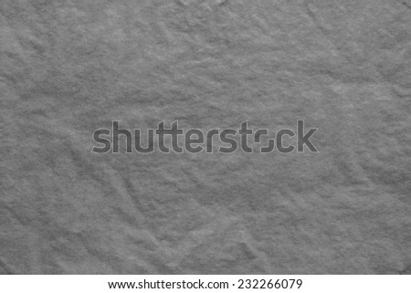 the dark-gray textured background from a thin tissue paper or a tracing-paper