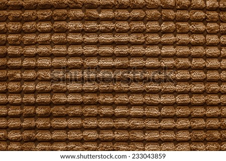 soft fluffy texture of terry checkered fabric of brown color for empty and pure backgrounds