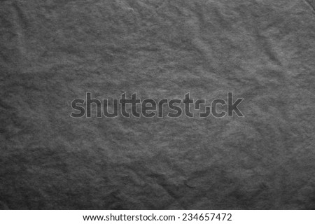 the textured clean sheet of crumpled paper of black color for pure and empty backgrounds
