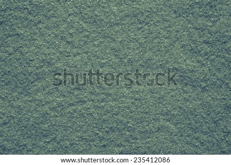 the pure textured surface of felt fabric of green color for empty backgrounds