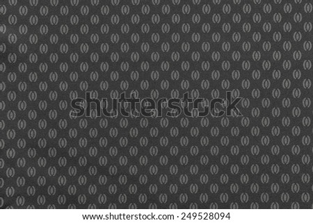 texture of dark gray color of textile fabric for wallpapers and for backgrounds with the repeating abstract drawing from ovals and ellipses