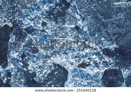 the broken ice textured surface of the frozen water for empty abstract backgrounds of blue color