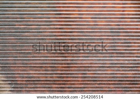 red-brown abstract fragment of dirty metal blinds for the abstract textured backgrounds