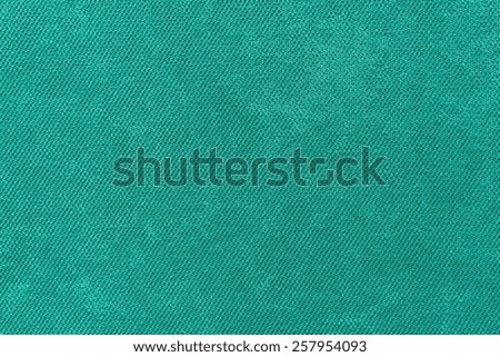 abstract grained texture of textile fabric of green color for empty and pure backgrounds