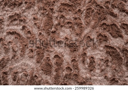 abstract texture of brown-haired fur fabric with ringlets and curls for background surfaces and for wallpaper