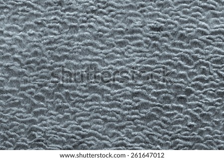 abstract texture of silvery color of short-haired fur fabric with wavy curls for empty backgrounds