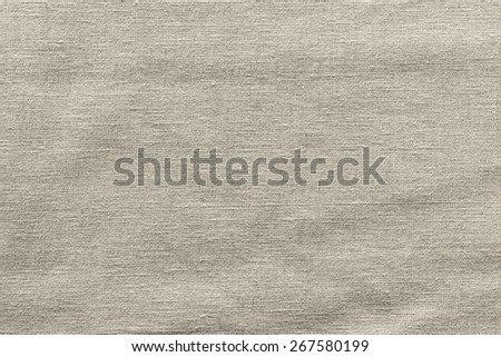 rough woven abstract texture of textile fabric of beige color for empty and pure backgrounds