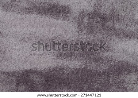abstract grained texture of spotty fabric of dark lilac color for empty and pure backgrounds