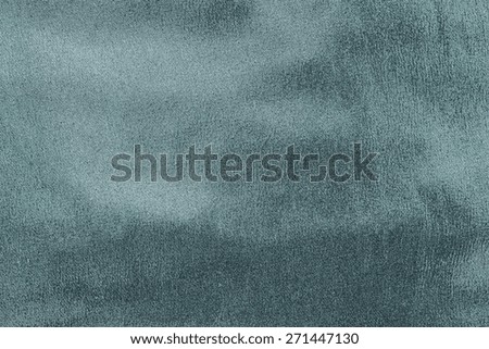 abstract grained texture of spotty fabric of dark indigo color for empty and pure backgrounds
