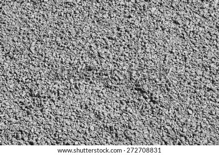 the rough crushed stone surface of gray color for the textured empty and pure backgrounds