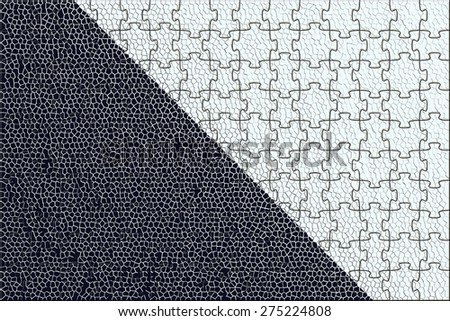 abstract symmetric monochrome background from two diagonal geometrical figures of black and white color and puzzles of mesh texture