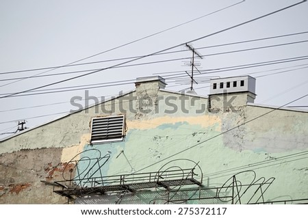 side wall of the old house with rusty metal designs for architectural abstractions
