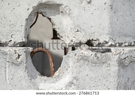 gray concrete plate and rusty arm for installation closeup