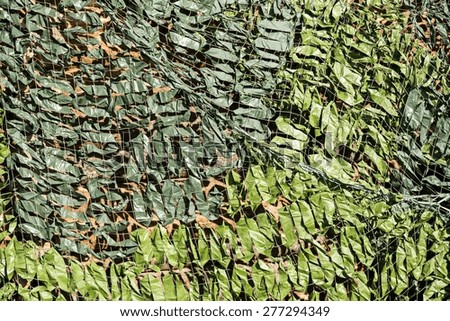 dense camouflage grid of green color for the abstract textured backgrounds