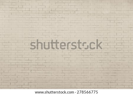 the pale beige textured surface of a brick wall for empty and pure backgrounds