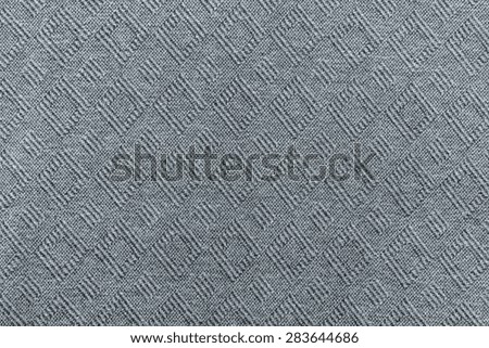 textured of knitted fabric a herringbone with a rhombic pattern for empty and pure abstract backgrounds of silvery gray color