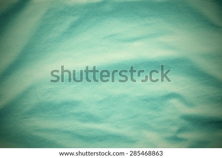 leather of turquoise color with crumpled corrugated grained texture for empty and pure abstract backgrounds