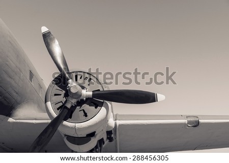 part of a retro of the plane with the propeller closeup in beige tones and a place for the text in the sky