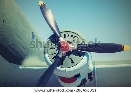 part of the plane with the propeller closeup in retro tones and a place for the text in the sky