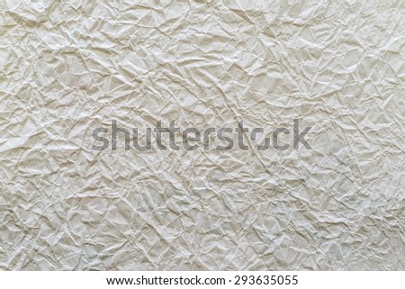 texture of old crumpled paper closeup of dirty beige color for empty and pure backgrounds