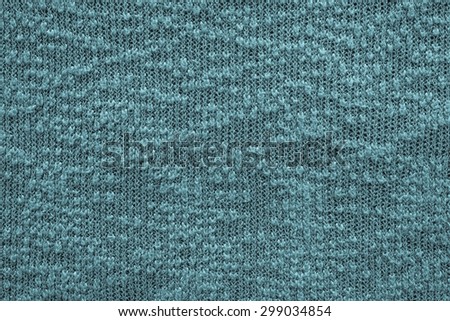 abstract knitted texture of dark blue green color closeup for backgrounds with a blank space for the text