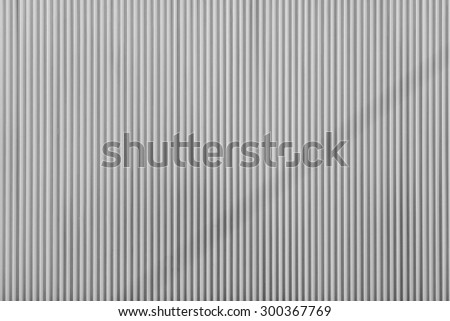 gray color corrugated wavy texture of a surface of an iron leaf for empty and pure backgrounds and for wallpaper