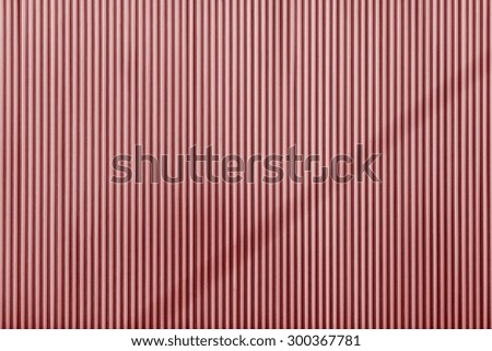 red color corrugated wavy texture of a surface of an iron leaf for empty and pure backgrounds and for wallpaper