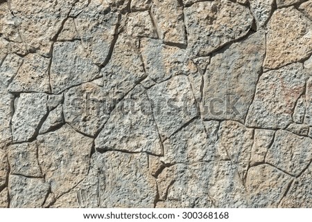 abstract texture of dark color of a stone wall with cracks for empty and pure backgrounds and for wallpaper