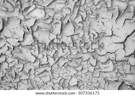 abstract gray texture for backgrounds with cracks and with a peel of the shriveled sandy soil