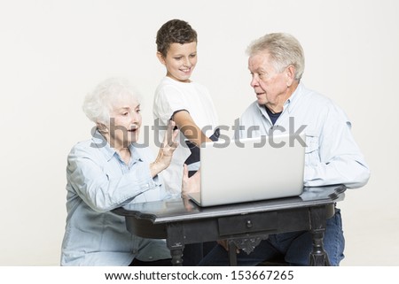 Grandson explains computer problems to grandparents