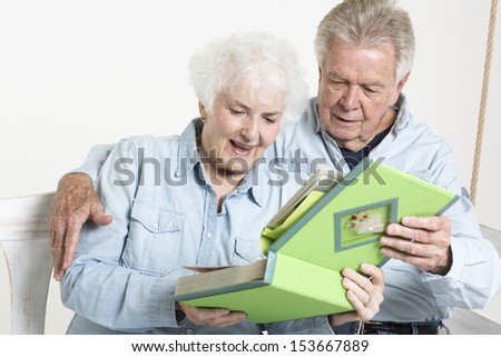 Senior couple looks at picture album