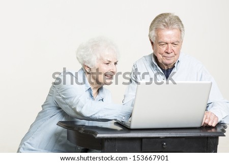 Senior couple looks at computer screen