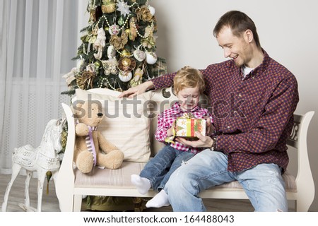 Father gives Christmas gift to his son