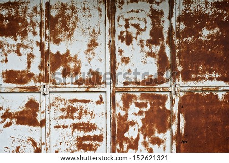Old metal sliding door with peeling paint work texture.