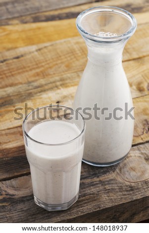 Almond milk. Healthy blended almond on wooden table. Studio shot at daylight, shallow depth of field.