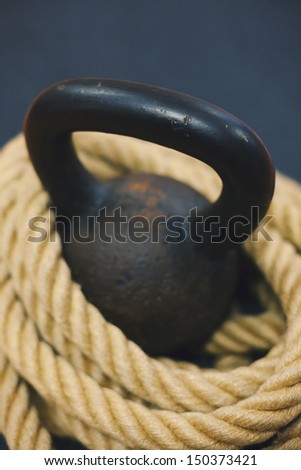 Kettle bell.  Cast iron kettle bell with rope. Exercise equipment.