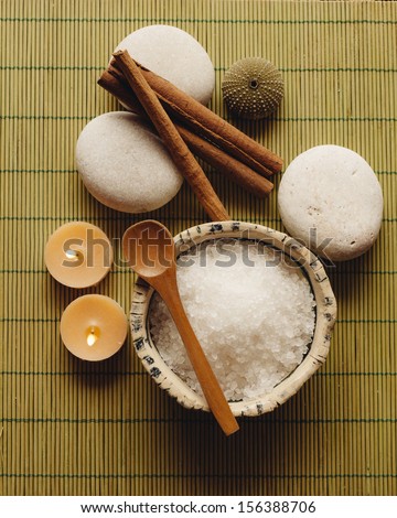 Spa supplies. Sea salt, pebble, cinnamon and candles in a zen spa atmosphere.