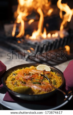 Shrimp rice with vegetables in a pan just prepared on the barbecue flame.
