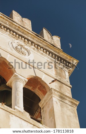 Greek architecture. Part of an old building against the sky and moon.