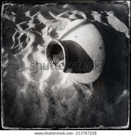 Old jug in the sand. Black and wet plate collodion photo.