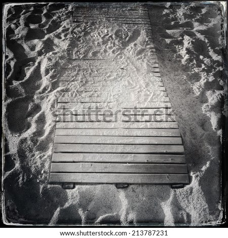 Wooden boardwalk in the sand. Black and wet plate collodion photo.
